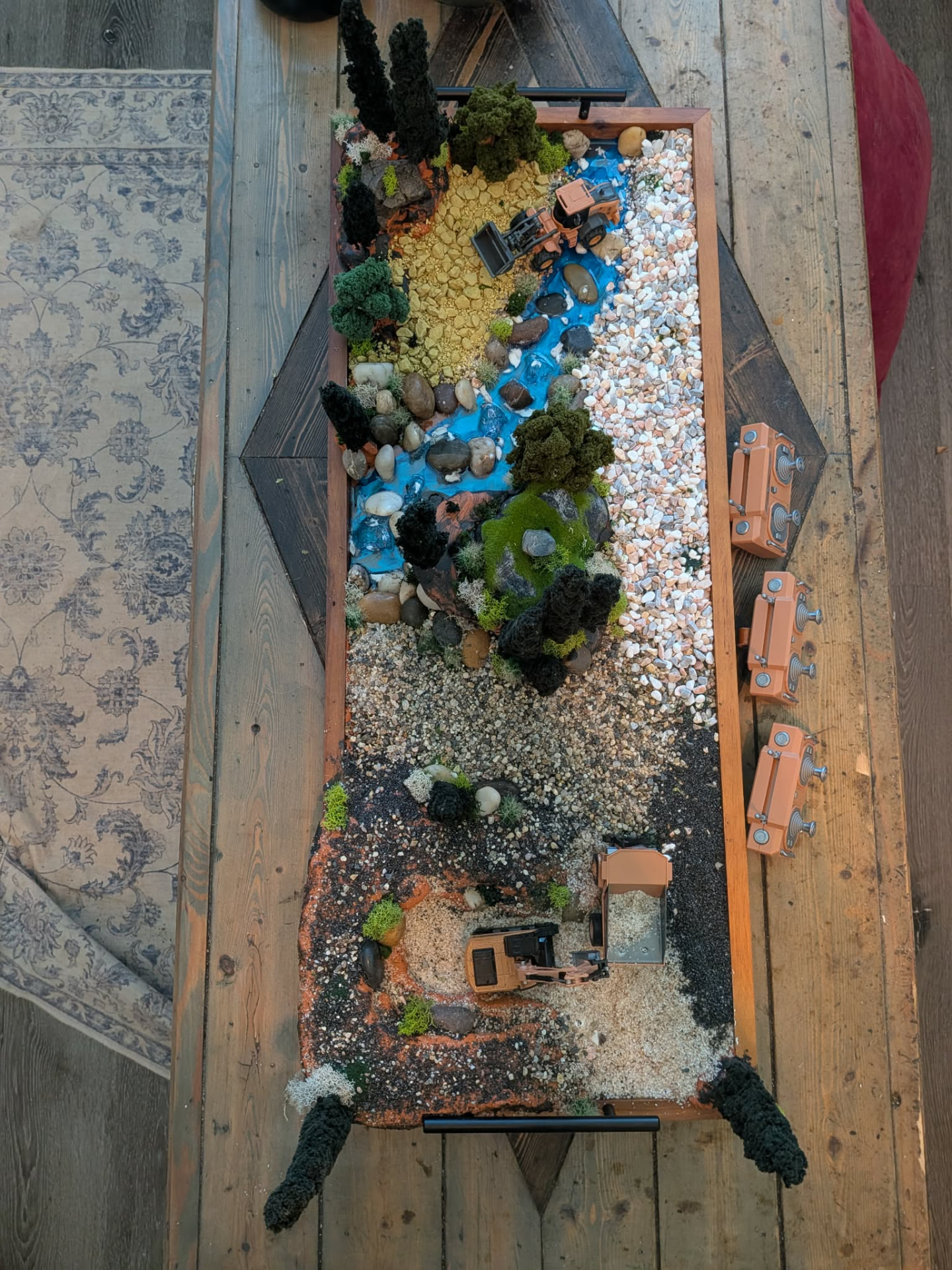 Top-down photo of the handcrafted Grand Dig terrain board with stream, gravel wash and quarry